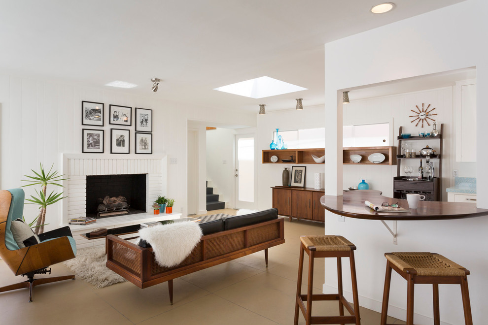 Midcentury open concept living room in Los Angeles with white walls, a standard fireplace, a brick fireplace surround, no tv and beige floor.