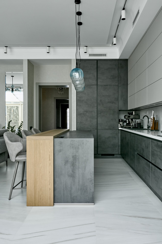 Inspiration for a contemporary open plan kitchen in Moscow with a drop-in sink, flat-panel cabinets, grey cabinets, solid surface benchtops, white splashback, porcelain floors, with island, white floor, white benchtop and recessed.