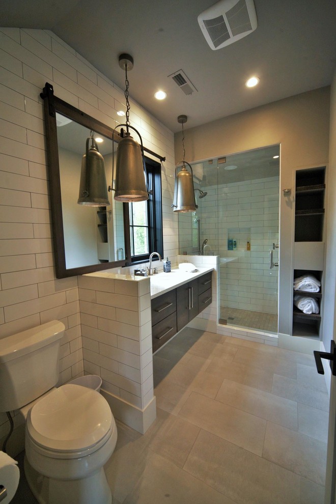 Photo of a mid-sized country 3/4 bathroom in Dallas with flat-panel cabinets, medium wood cabinets, an alcove shower, a two-piece toilet, white tile, subway tile, brown walls, an undermount sink and engineered quartz benchtops.
