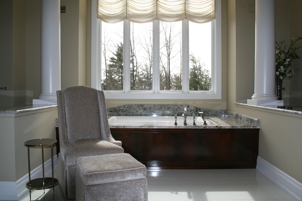 Huge transitional master white tile and glass tile gray floor drop-in bathtub photo with furniture-like cabinets, gray cabinets, granite countertops and beige walls