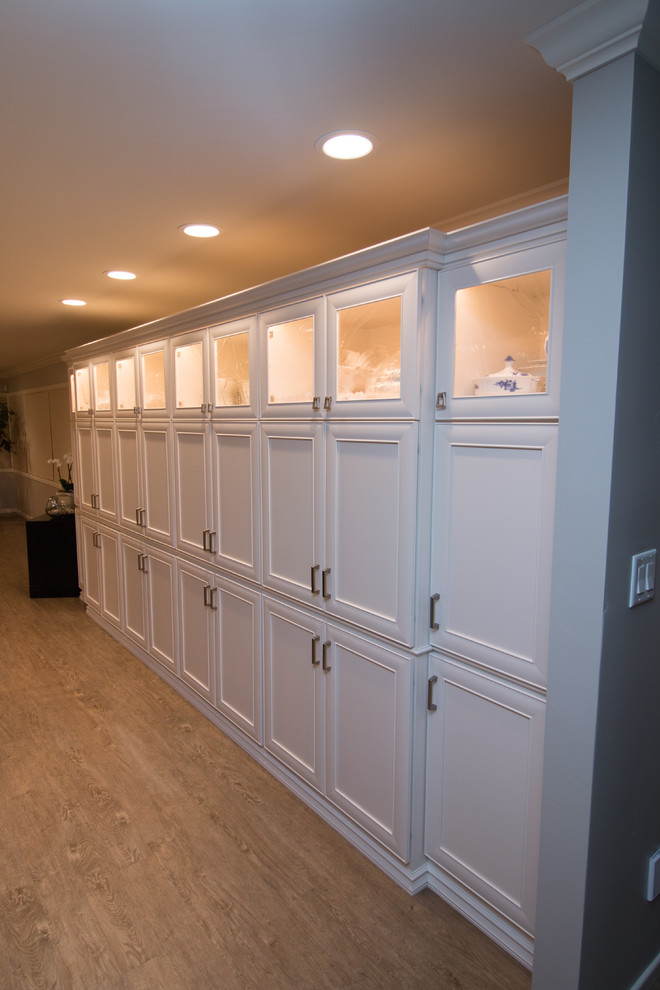 Open concept kitchen - huge transitional open concept kitchen idea with a farmhouse sink, recessed-panel cabinets, white cabinets, quartz countertops, beige backsplash, stone tile backsplash, stainless steel appliances and an island