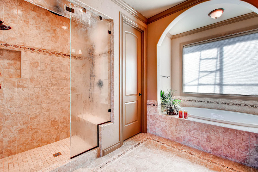 This is an example of a large country master bathroom in Denver with granite benchtops, a drop-in tub, an open shower, beige tile, ceramic tile, beige walls and ceramic floors.