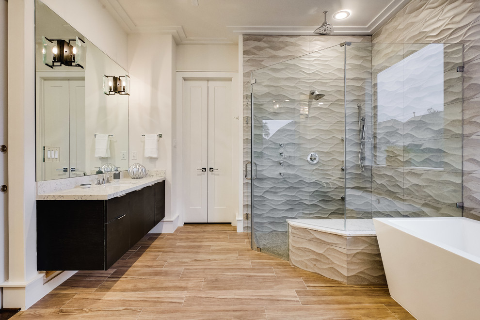 Inspiration for a transitional bathroom in Houston with flat-panel cabinets, black cabinets, a freestanding tub, a curbless shower, gray tile, white walls, medium hardwood floors, an undermount sink, brown floor and a hinged shower door.