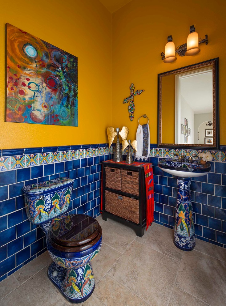Design ideas for a powder room in San Diego with blue tile, yellow walls, a pedestal sink and beige floor.