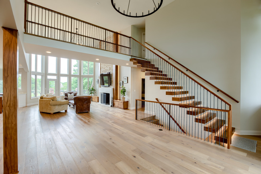 Example of a transitional light wood floor entryway design