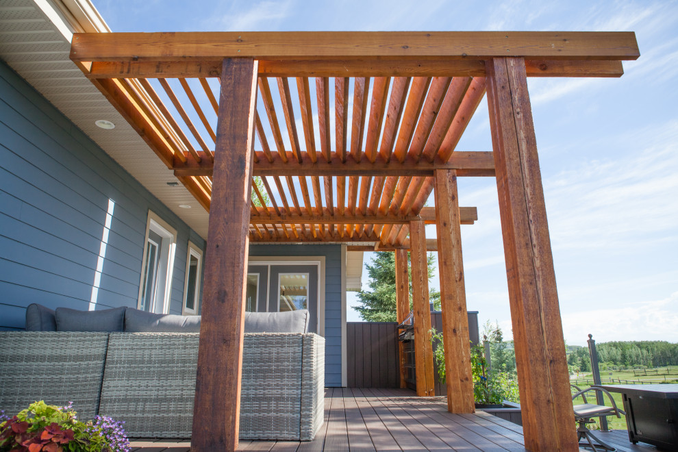 Inspiration for a mid-sized contemporary backyard deck remodel in Calgary with a pergola
