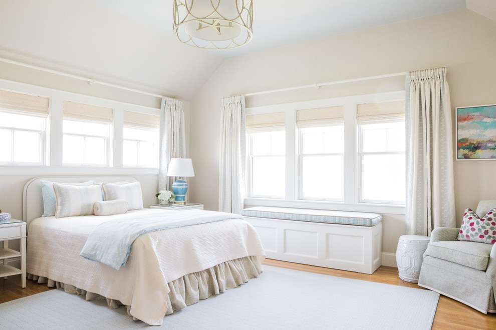 This is an example of a beach style guest bedroom in Boston with beige walls and carpet.
