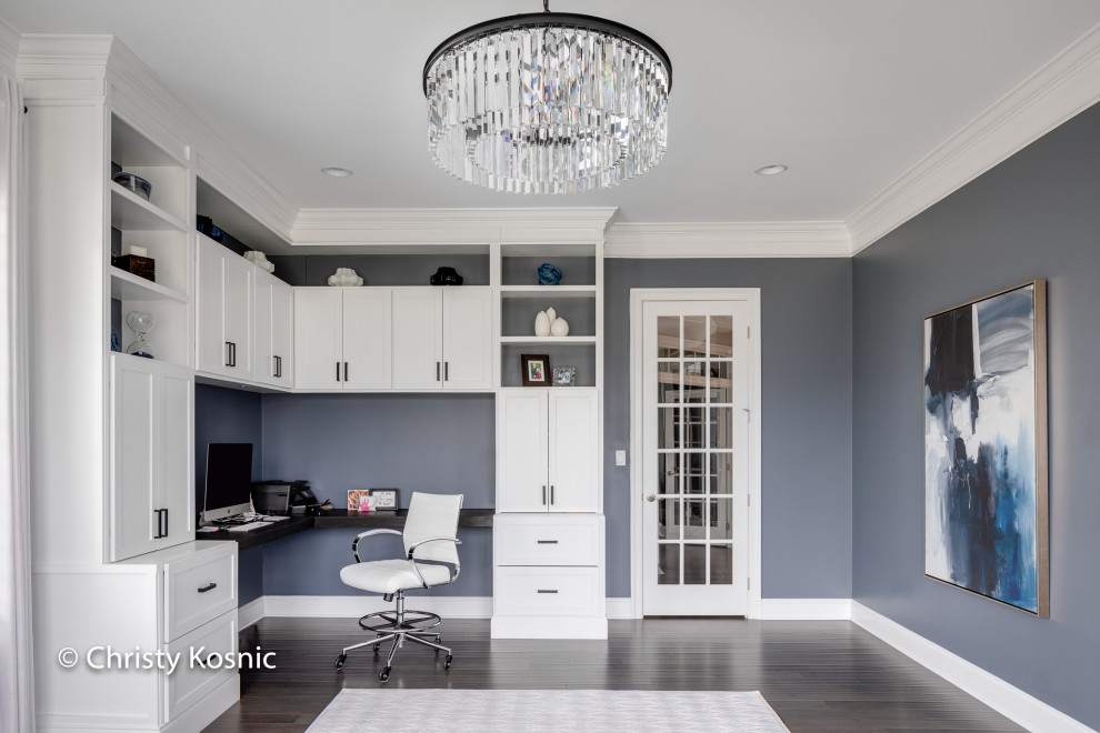 Design ideas for a transitional home office in DC Metro with blue walls and a built-in desk.