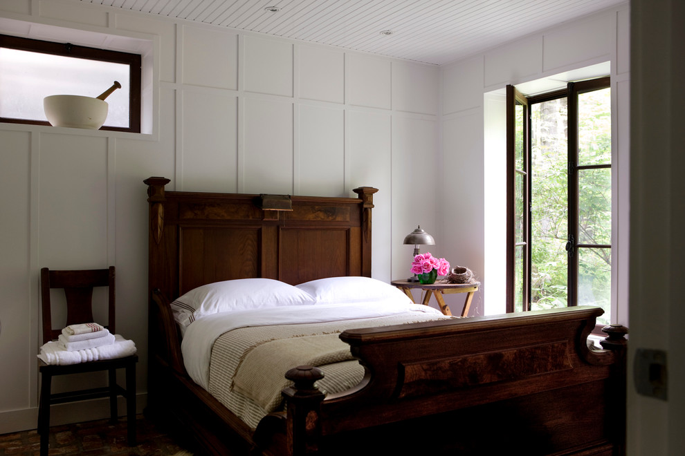 Inspiration for a country guest bedroom in Montreal with white walls, dark hardwood floors and no fireplace.