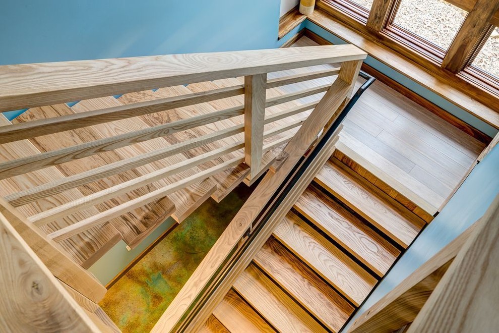 Design ideas for a mid-sized contemporary wood u-shaped staircase in Other with open risers and wood railing.