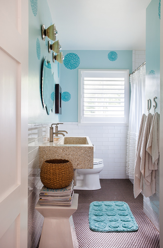 Design ideas for a mid-sized contemporary kids bathroom in Atlanta with a trough sink, concrete benchtops, an alcove tub, a one-piece toilet, white tile, ceramic tile, blue walls, mosaic tile floors and a shower curtain.