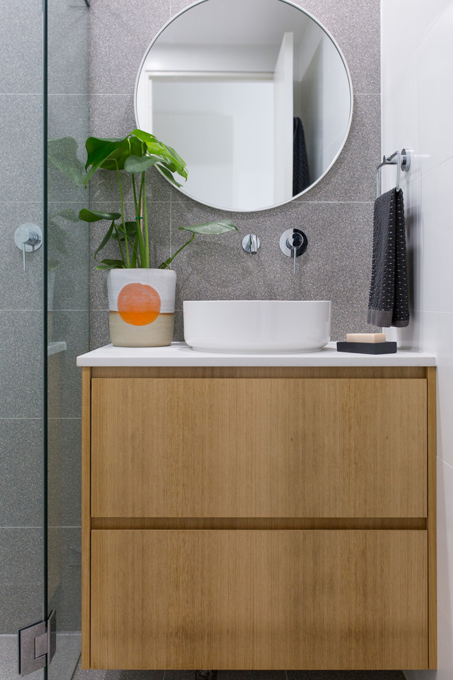 Photo of a small contemporary bathroom in Sydney with beaded inset cabinets, light wood cabinets and granite benchtops.