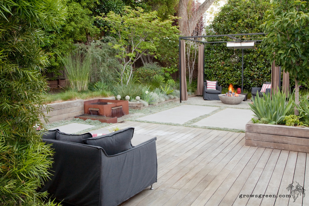Design ideas for a mid-sized modern backyard full sun xeriscape in San Francisco with a fire feature and concrete pavers.