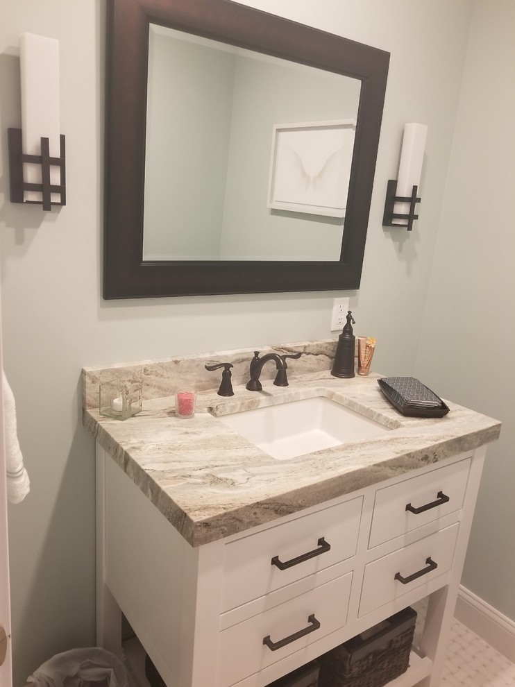 Design ideas for a small contemporary powder room in New York with white cabinets, granite benchtops, flat-panel cabinets, a two-piece toilet, green walls, ceramic floors, a drop-in sink, white floor and beige benchtops.