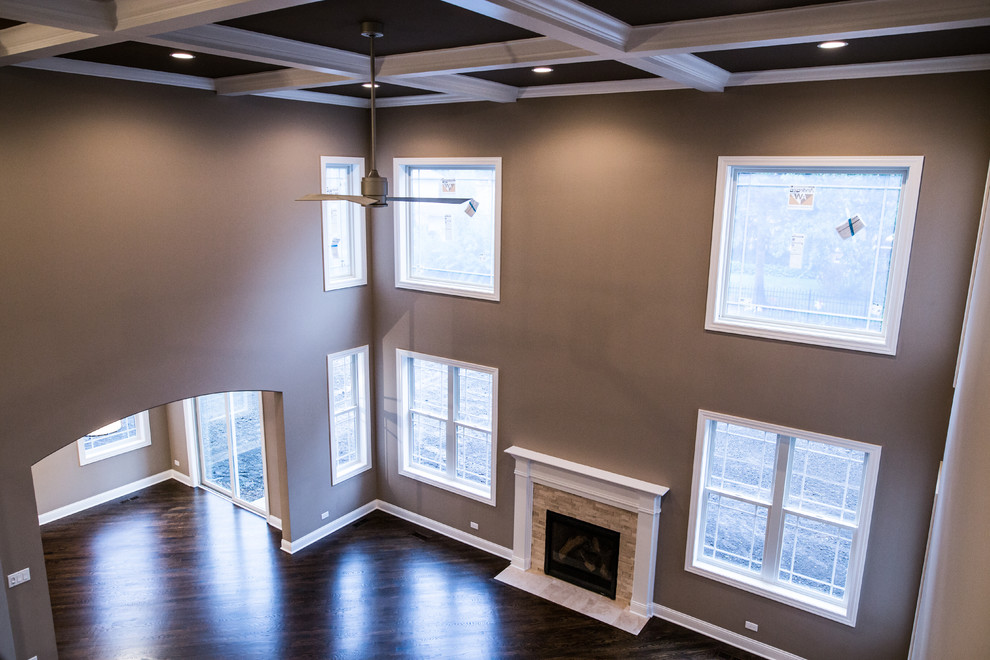 Example of a huge transitional formal and open concept dark wood floor home design design in Chicago with brown walls, a standard fireplace, a stone fireplace and no tv