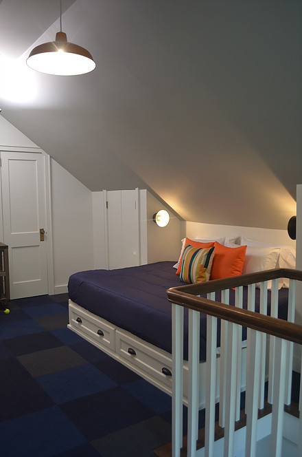 This is an example of a mid-sized beach style kids' room for kids 4-10 years old and boys in Other with white walls, carpet and blue floor.