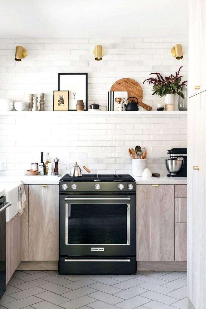 This is an example of a small contemporary u-shaped separate kitchen in Salt Lake City with a farmhouse sink, flat-panel cabinets, grey cabinets, subway tile splashback, black appliances and white floor.