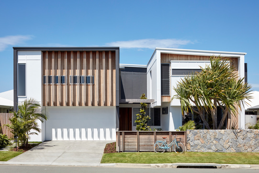 Photo of a contemporary two-storey multi-coloured house exterior in Brisbane with mixed siding and a shed roof.