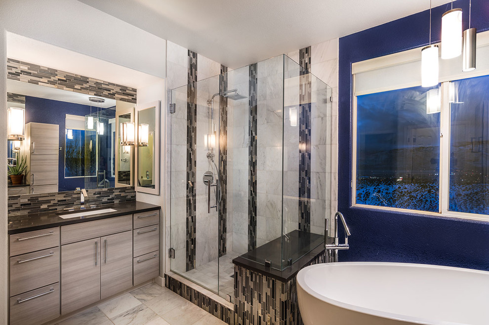 Freestanding bathtub - contemporary master beige tile and porcelain tile porcelain tile and beige floor freestanding bathtub idea with flat-panel cabinets, brown cabinets, blue walls, an undermount sink and a hinged shower door