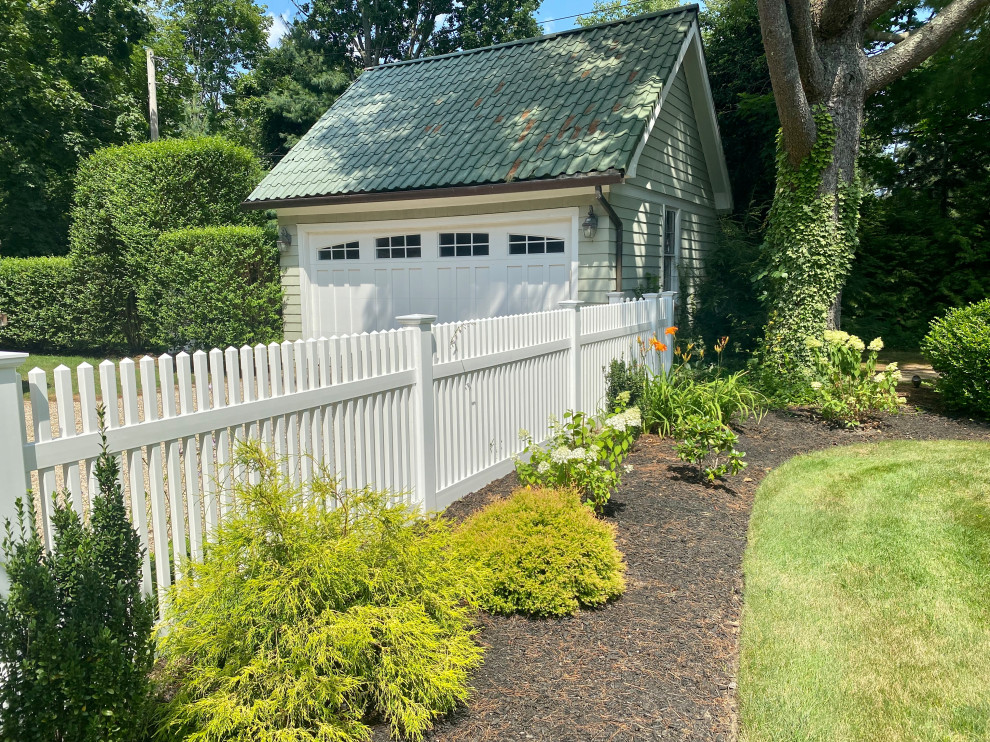 Design ideas for a traditional garden in New York with with a gate and a vinyl fence.