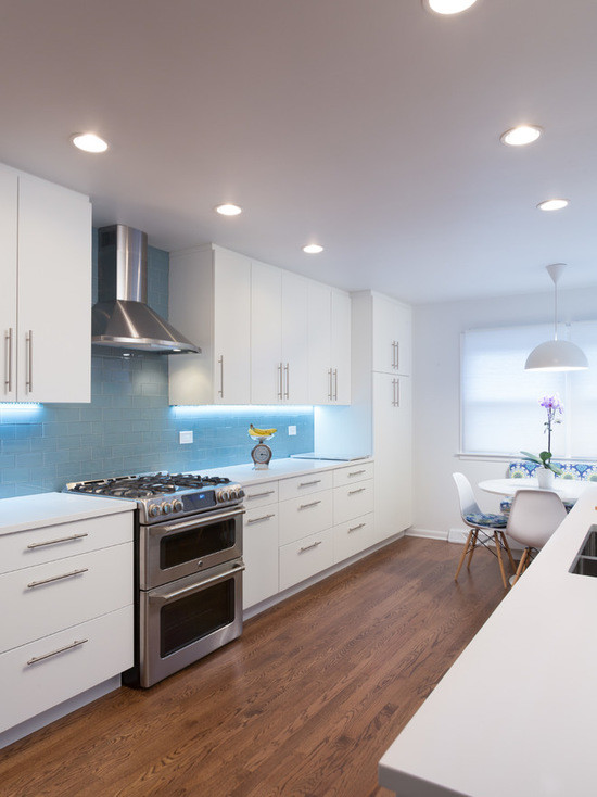 Inspiration for a mid-sized modern galley eat-in kitchen in Chicago with an undermount sink, flat-panel cabinets, white cabinets, copper benchtops, blue splashback, subway tile splashback, stainless steel appliances, medium hardwood floors and no island.