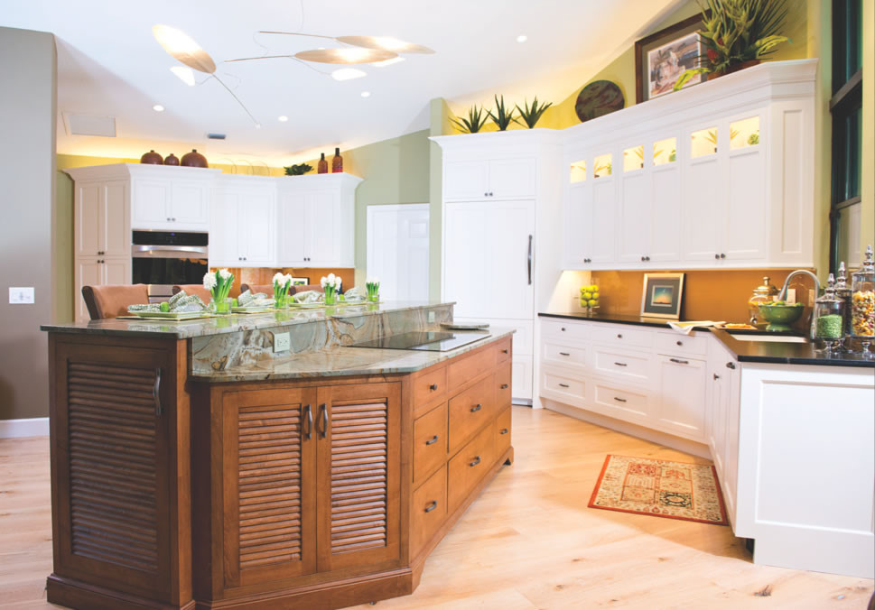 Inspiration for a large transitional l-shaped light wood floor and brown floor eat-in kitchen remodel in Tampa with an undermount sink, shaker cabinets, white cabinets, granite countertops, brown backsplash, glass sheet backsplash, paneled appliances and an island