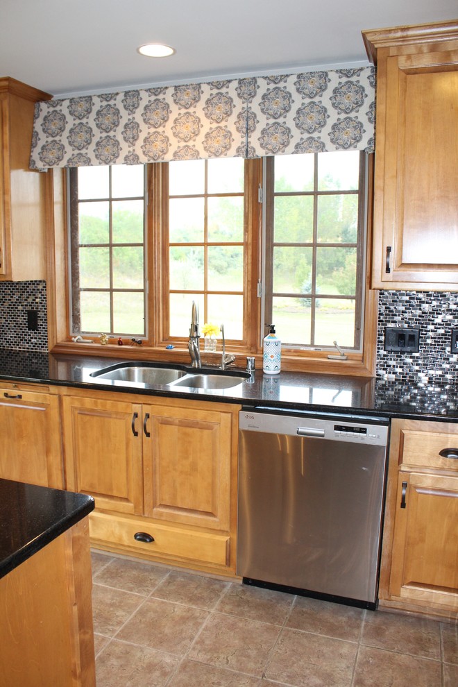 Open concept kitchen - mid-sized transitional u-shaped ceramic tile and beige floor open concept kitchen idea in Milwaukee with an undermount sink, raised-panel cabinets, medium tone wood cabinets, granite countertops, multicolored backsplash, glass tile backsplash, stainless steel appliances and two islands