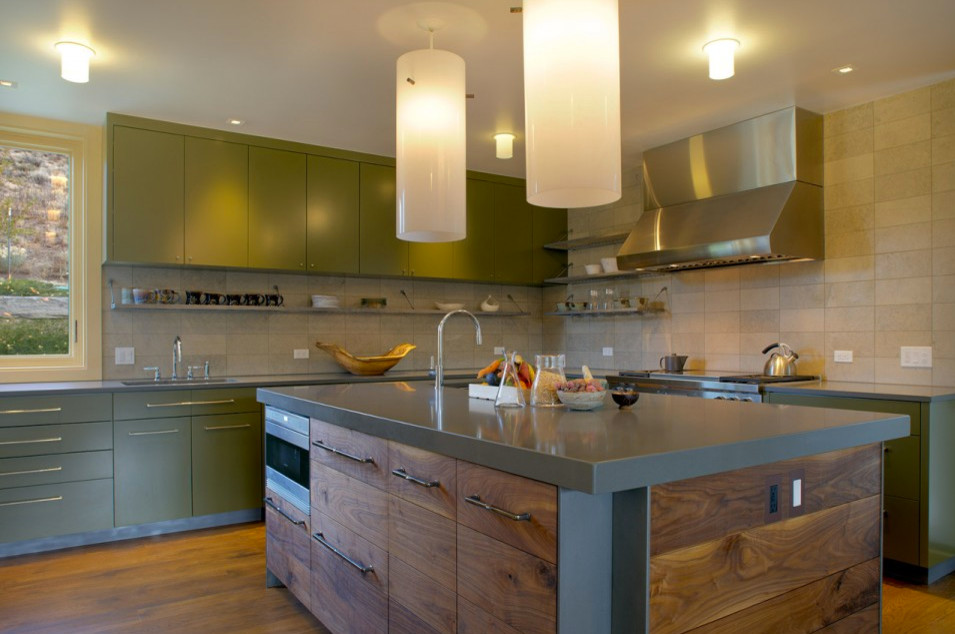 This is an example of a mid-sized midcentury l-shaped separate kitchen in Other with an undermount sink, flat-panel cabinets, green cabinets, quartz benchtops, beige splashback, stone tile splashback, stainless steel appliances, medium hardwood floors and with island.