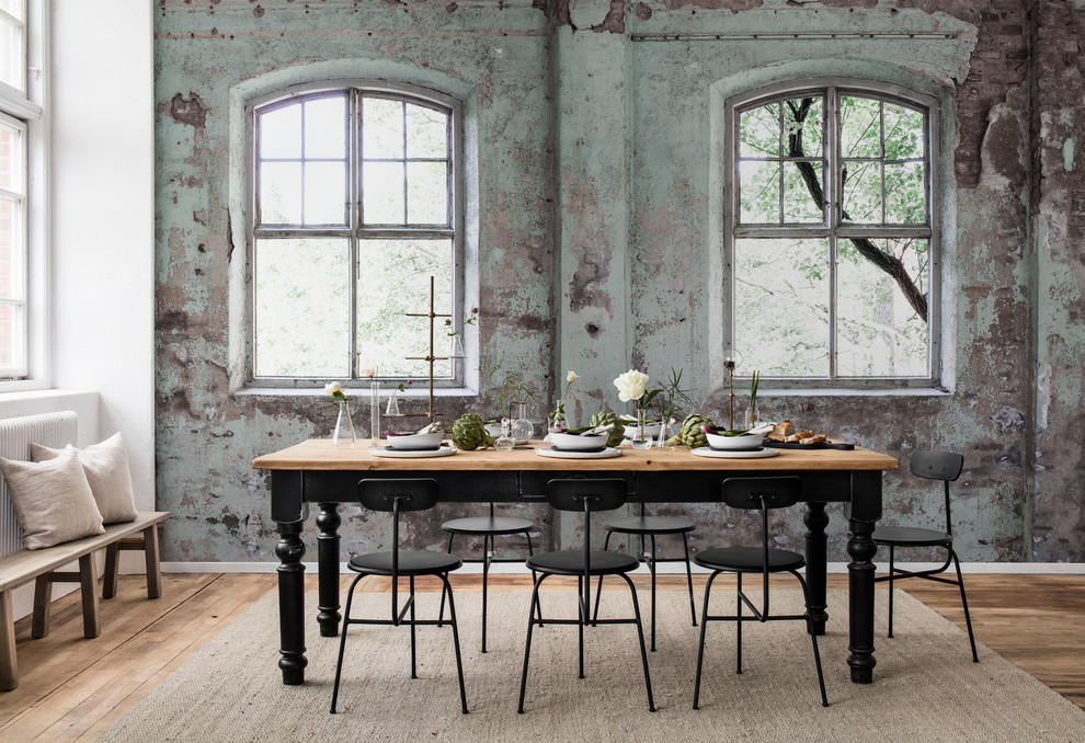 This is an example of a medium sized industrial open plan dining room in Gothenburg with green walls, medium hardwood flooring, no fireplace and brown floors.