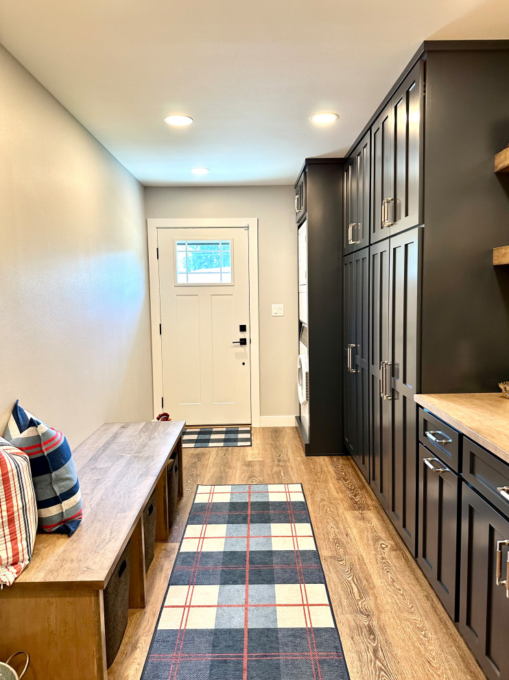 Mid-sized transitional medium tone wood floor and brown floor entry hall photo with white walls and a white front door