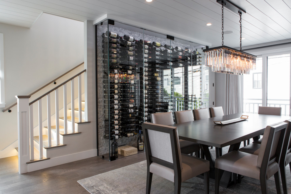 This is an example of a small beach style wine cellar in Los Angeles with medium hardwood floors, storage racks and grey floor.