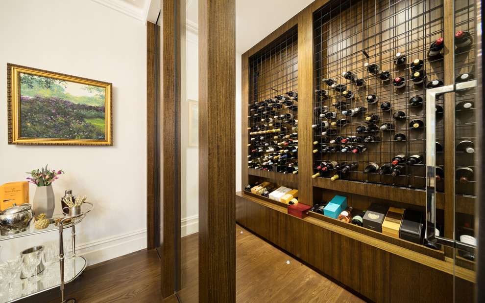 Photo of a contemporary wine cellar in Melbourne with dark hardwood floors, storage racks and brown floor.