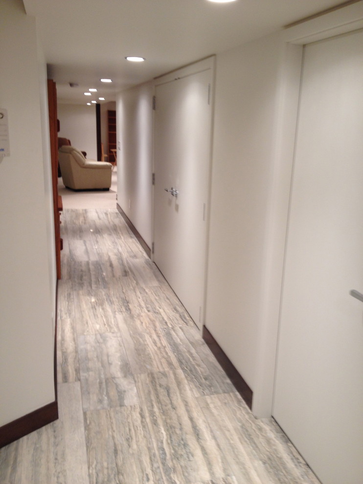 Photo of a mid-sized midcentury hallway in Other with white walls and travertine floors.