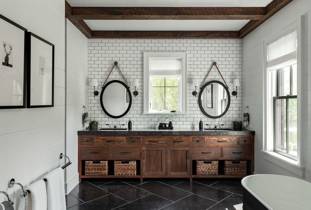 This is an example of a large country master bathroom in New York with flat-panel cabinets, a freestanding tub, white tile, subway tile, white walls, slate floors, an undermount sink, concrete benchtops, black floor, black benchtops and dark wood cabinets.