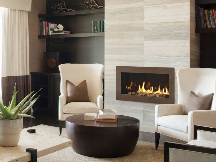 This is an example of a small contemporary enclosed living room in Minneapolis with beige walls, porcelain floors, a standard fireplace, a stone fireplace surround and no tv.