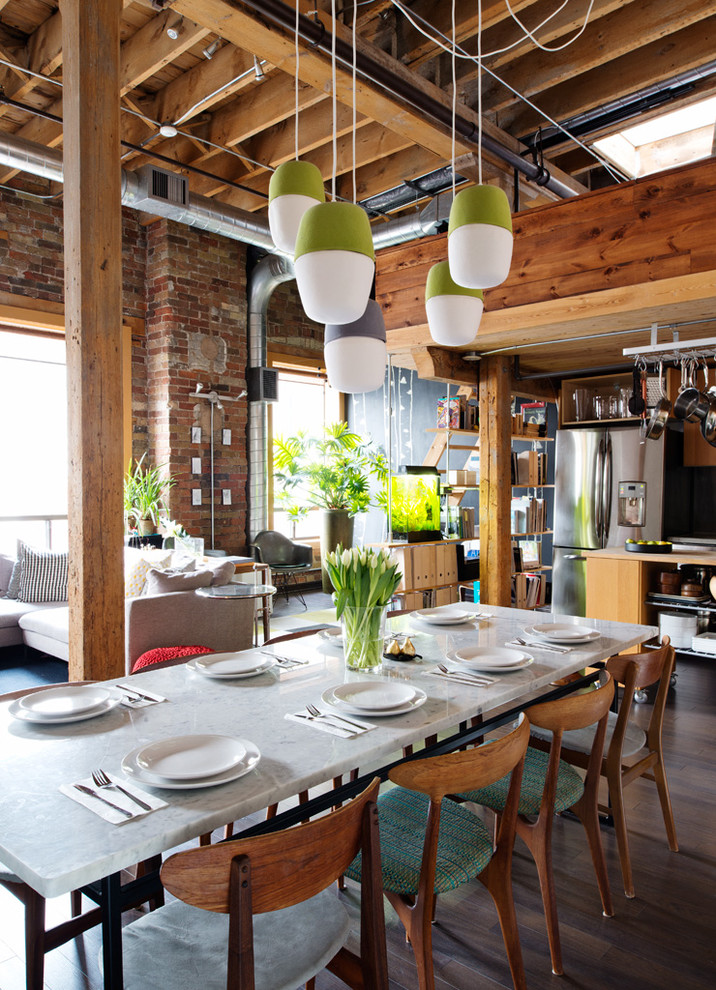 Design ideas for an industrial open plan dining in Toronto with dark hardwood floors and brown floor.