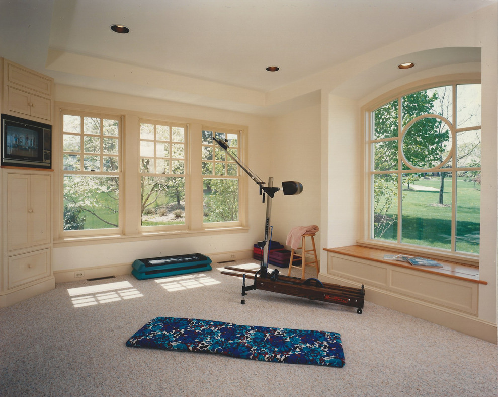This is an example of a small transitional home yoga studio in Philadelphia with white walls and carpet.