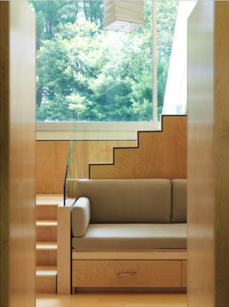 Photo of a mid-sized contemporary wood l-shaped staircase in Boston with wood risers and glass railing.