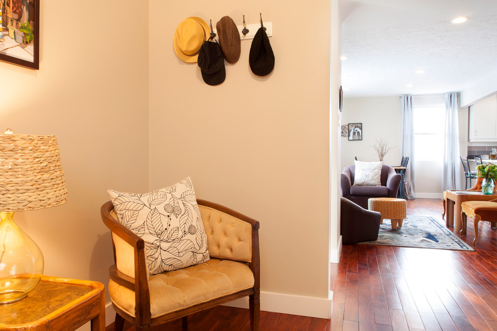This is an example of a mid-sized eclectic entryway in Vancouver with beige walls and dark hardwood floors.