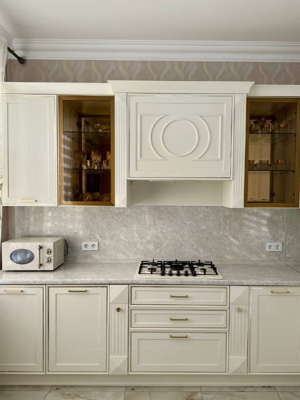 Inspiration for a mid-sized transitional l-shaped kitchen in Other with white cabinets, grey splashback, no island, grey benchtop and a drop-in sink.