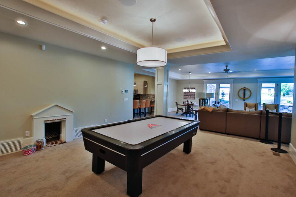 This is an example of a large transitional walk-out basement in Salt Lake City with beige walls and carpet.