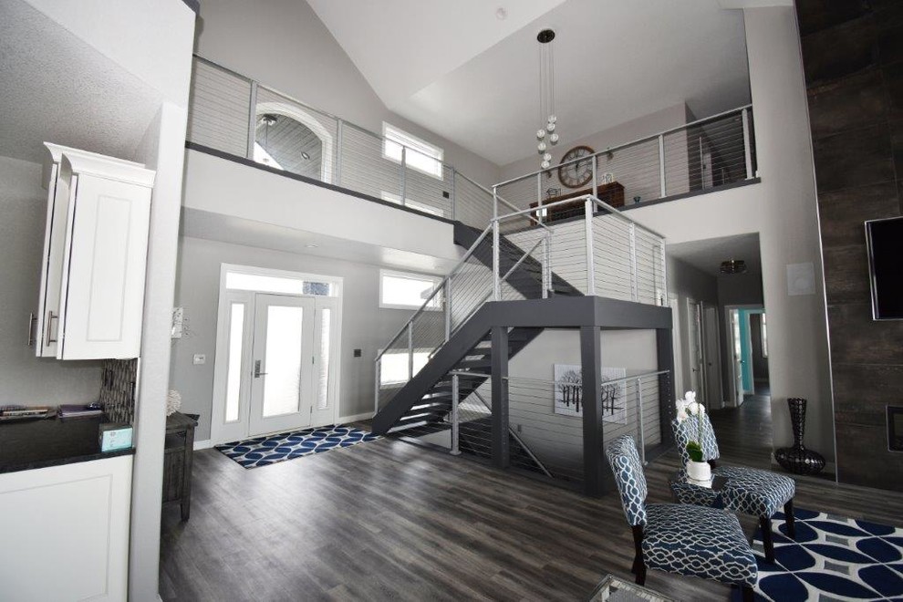 Mid-sized trendy vinyl floor and brown floor front door photo with gray walls and a glass front door