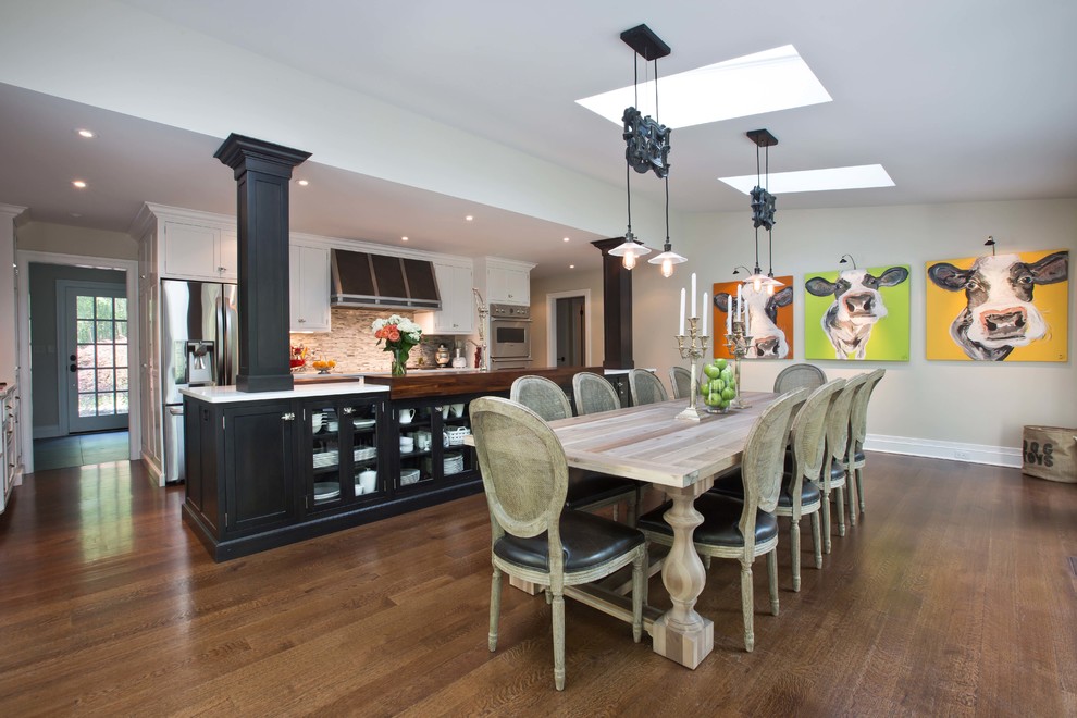 Inspiration for a transitional kitchen/dining combo in New York with white walls and dark hardwood floors.