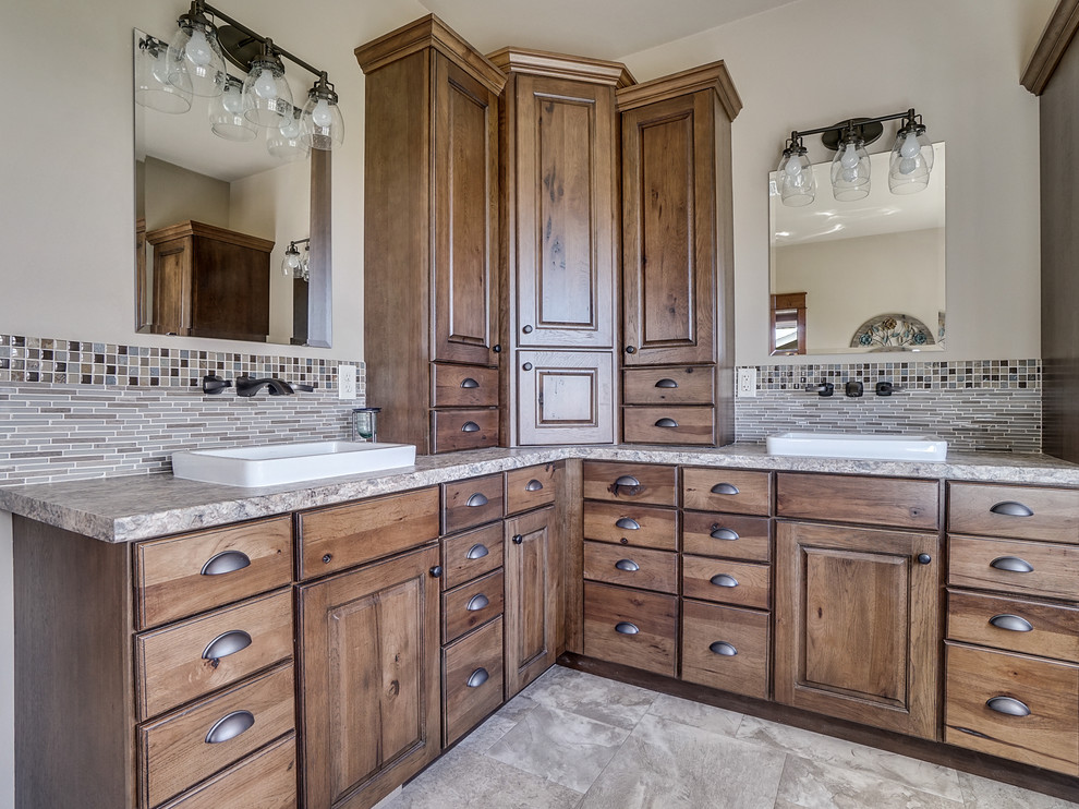 Mid-sized country master bathroom in Minneapolis with raised-panel cabinets, blue cabinets, a freestanding tub, an open shower, beige tile, mosaic tile, linoleum floors, grey floor and a hinged shower door.