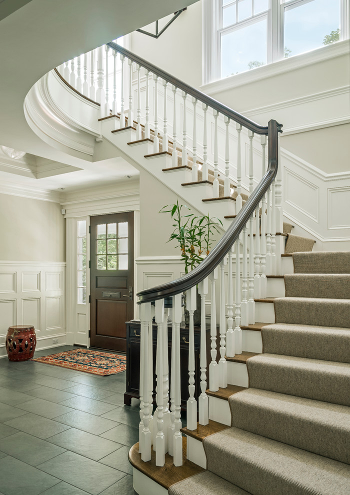 This is an example of a mid-sized traditional wood l-shaped staircase in Boston with painted wood risers and wood railing.