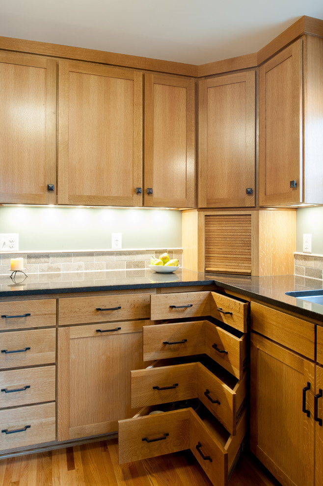 Mid-sized transitional light wood floor enclosed kitchen photo in Minneapolis with shaker cabinets, light wood cabinets, gray backsplash, stone tile backsplash, black appliances and no island