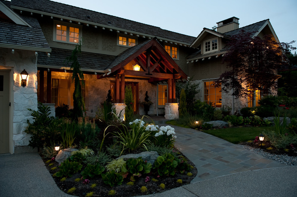 This is an example of a large traditional two-storey beige exterior in Seattle with stone veneer.