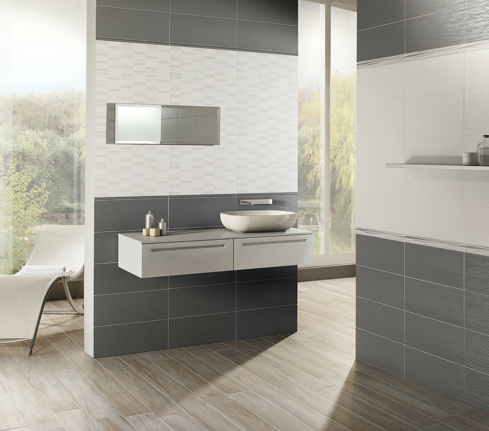 Minimalist gray tile and ceramic tile porcelain tile bathroom photo with a vessel sink and gray walls