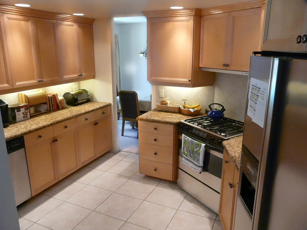 Mid-sized transitional l-shaped porcelain tile enclosed kitchen photo in San Diego with an undermount sink, recessed-panel cabinets, light wood cabinets, granite countertops, beige backsplash, porcelain backsplash, stainless steel appliances and no island