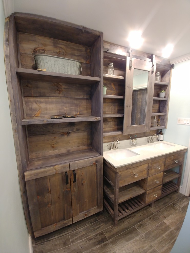 Bathroom - mid-sized rustic porcelain tile and brown floor bathroom idea in Toronto with furniture-like cabinets, distressed cabinets, a two-piece toilet, an undermount sink, quartzite countertops and white countertops